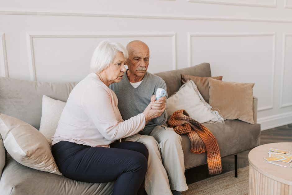 An older couple checking health information together at home.